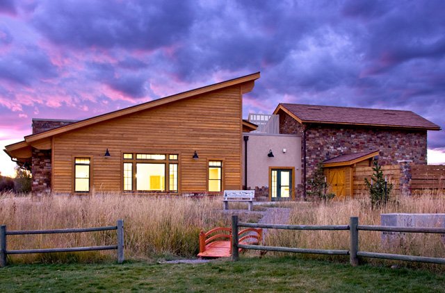 Image of a wood and stone building at dusk