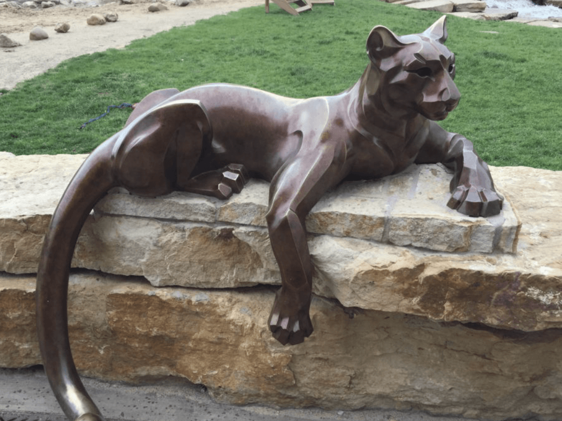 Cougar sculpture on stone wall