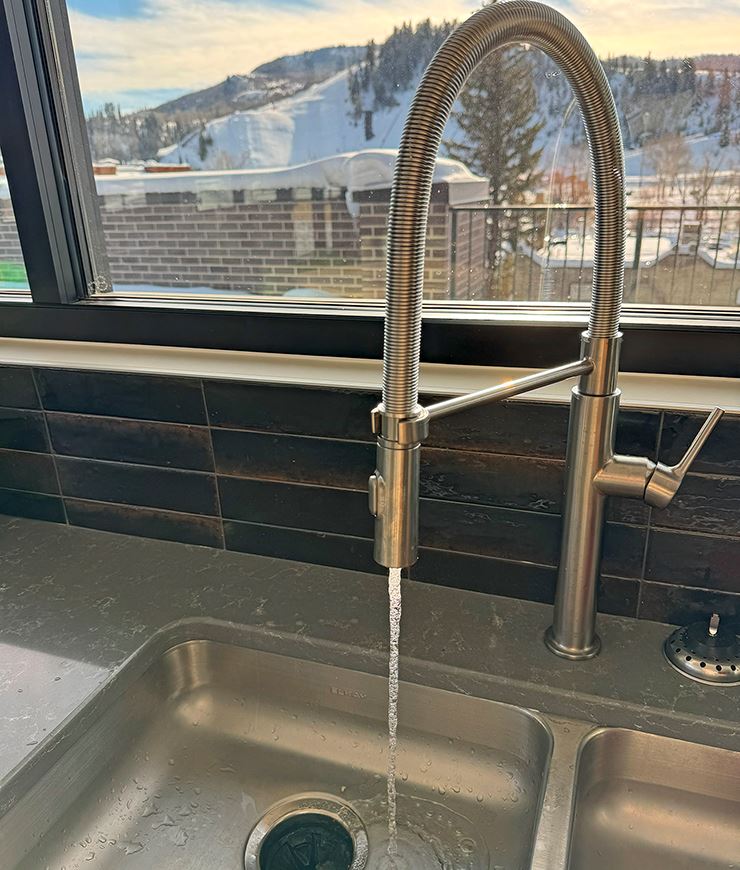 Kitchen sink with water flowing