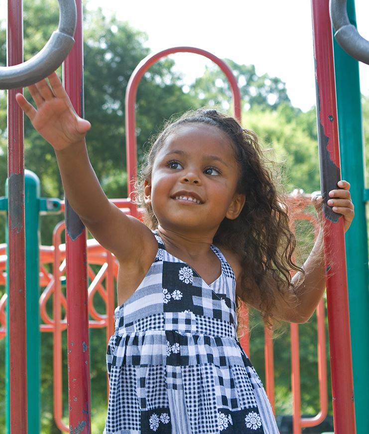 A girl enjoying a playground feature