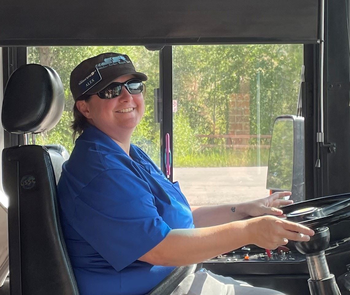 Bus driver sitting in the drivers seat of a SST bus.